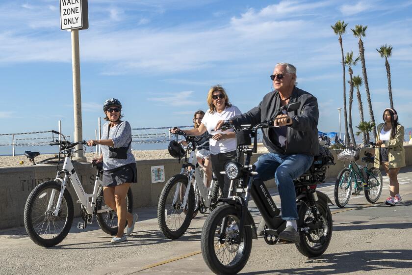 HERMOSA BEACH, CA-NOVEMBER 10, 2023, 2023:A man rides his e-bike on the Strand in Hermosa Beach as others walk their e-bikes in a walk only zone. In Hermosa Beach, it's against city code to use electric power on the Strand, but many e-bike riders do so anyway. (Mel Melcon / Los Angeles Times)'s against city code to use electric power on the Strand, but many e-bike riders do so anyway. (Mel Melcon / Los Angeles Times)